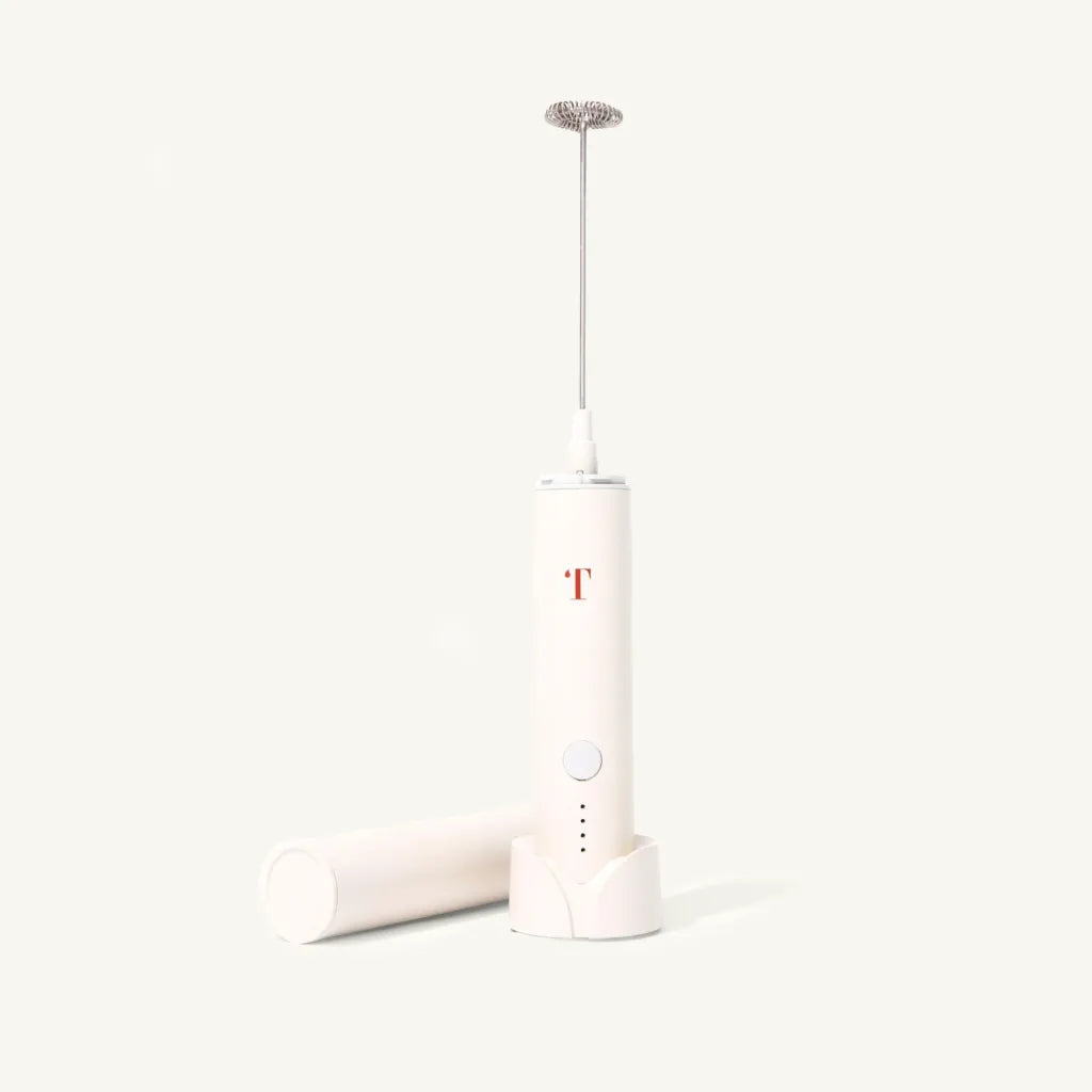 Cream colored milk frother with minimalist Rust Teaspressa "T" Logo