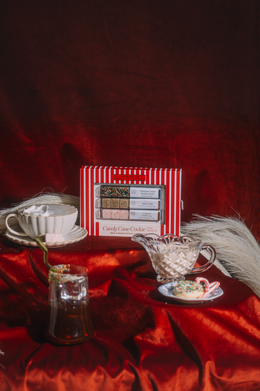 Red and white striped box with a tea set on a red fabric background