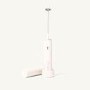 Cream colored milk frother with minimalist  Rust Teaspressa "T" Logo