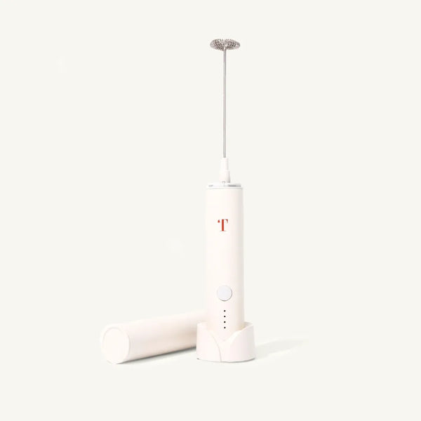 Cream colored milk frother with minimalist  Rust Teaspressa "T" Logo