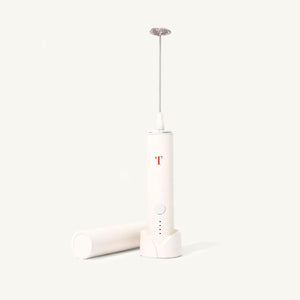 Cream colored milk frother with minimalist  Rust Teaspressa "T" Logo