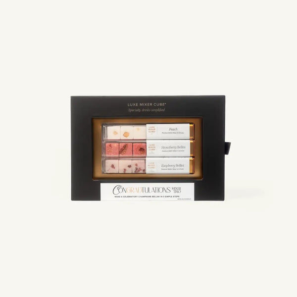 A gift box labeled Luxe Mixer Cube with three rows of cocktail mixer cubes in flavors: Peach Bellini, Strawberry Bellini, and Raspberry Bellini. The box has a Congra'D'tulations message on the front.