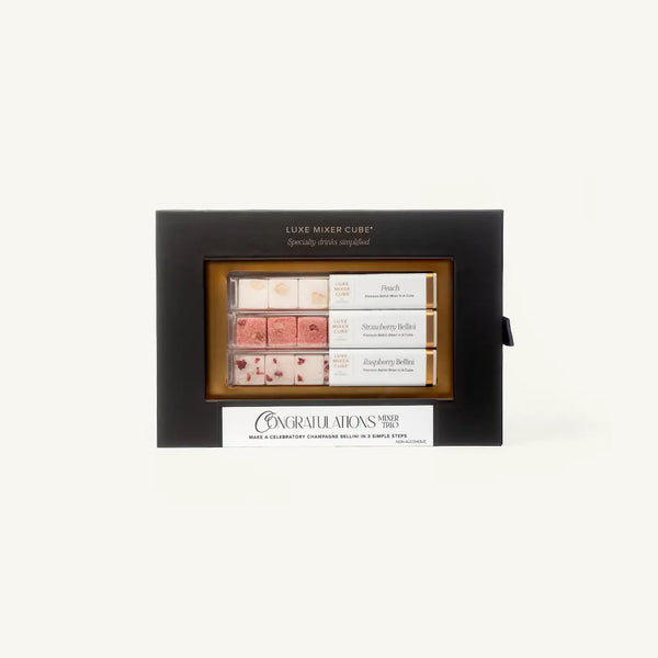 A gift box labeled Luxe Mixer Cube with three rows of cocktail mixer cubes in flavors: Peach Bellini, Strawberry Bellini, and Raspberry Bellini. The box has a Congratulations message on the front.