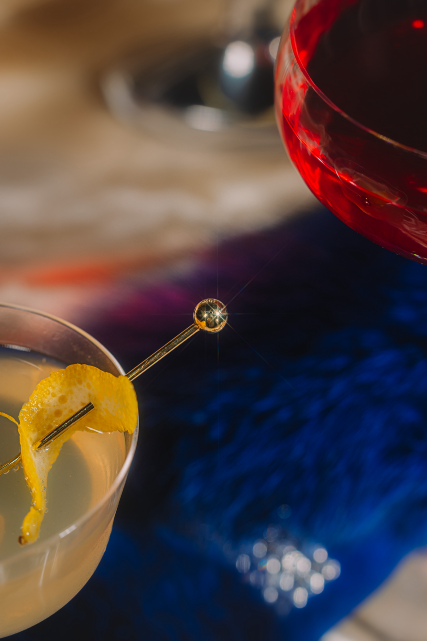 Close-up of a cocktail with a lemon twist on a blurred background